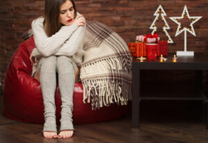 Sad woman with gift boxes